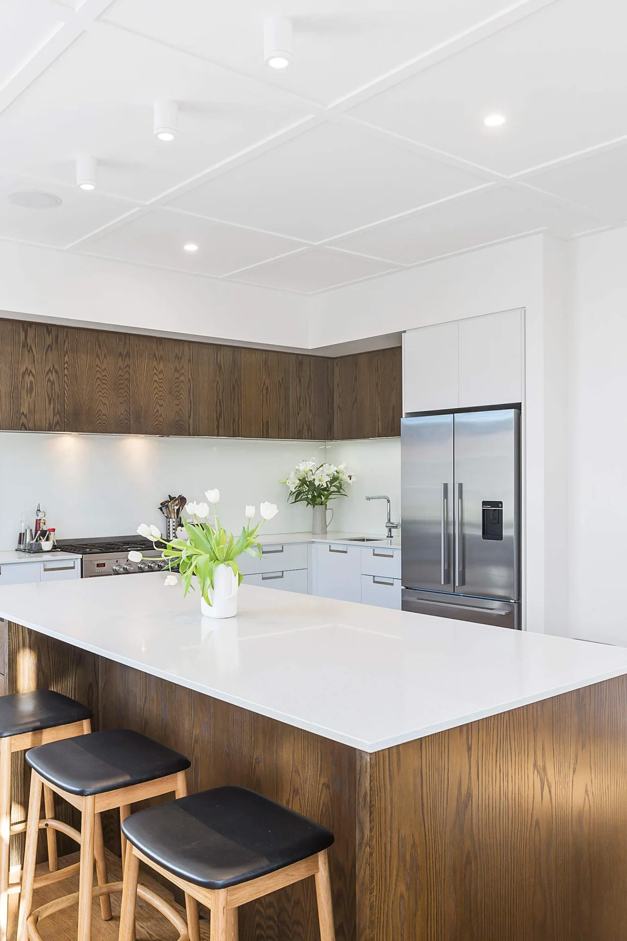 Renovated kitchen with timber cabinetry and a light stone island